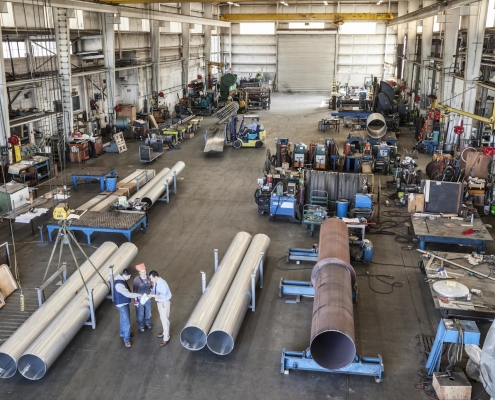Workers in a large manufacturing facility