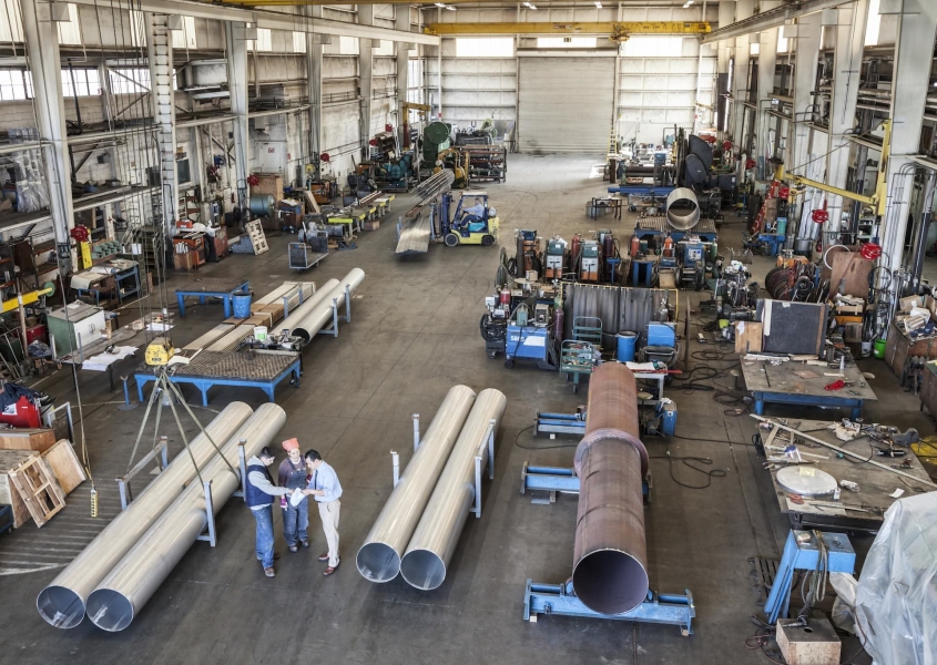 Workers in a large manufacturing facility