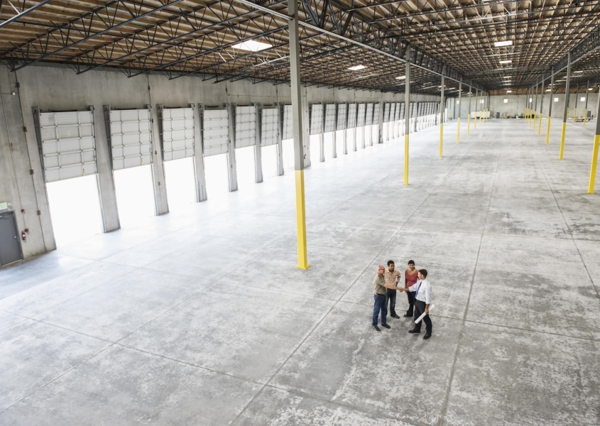 Incentives for Manufacturers being discussed in a large warehouse