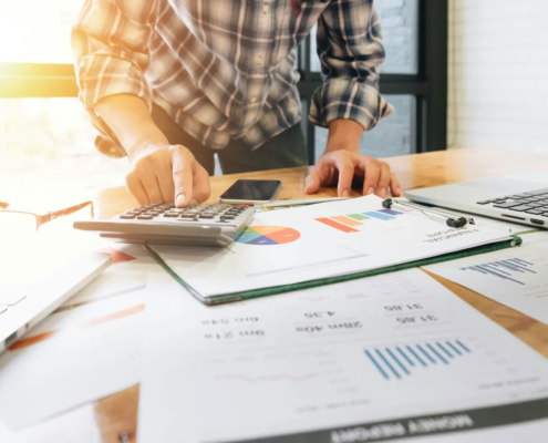 Calculator and financial reports representing careful analysis of tax incentives
