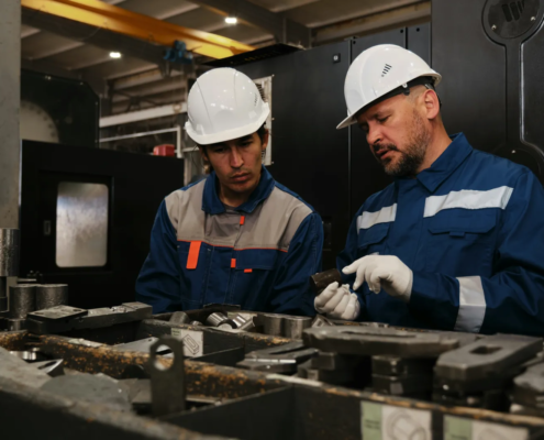 Skilled workers on a factory floor representing retention and productivity from workforce incentives