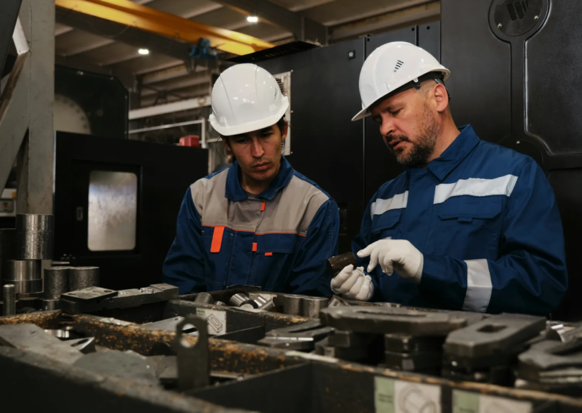 Skilled workers on a factory floor representing retention and productivity from workforce incentives